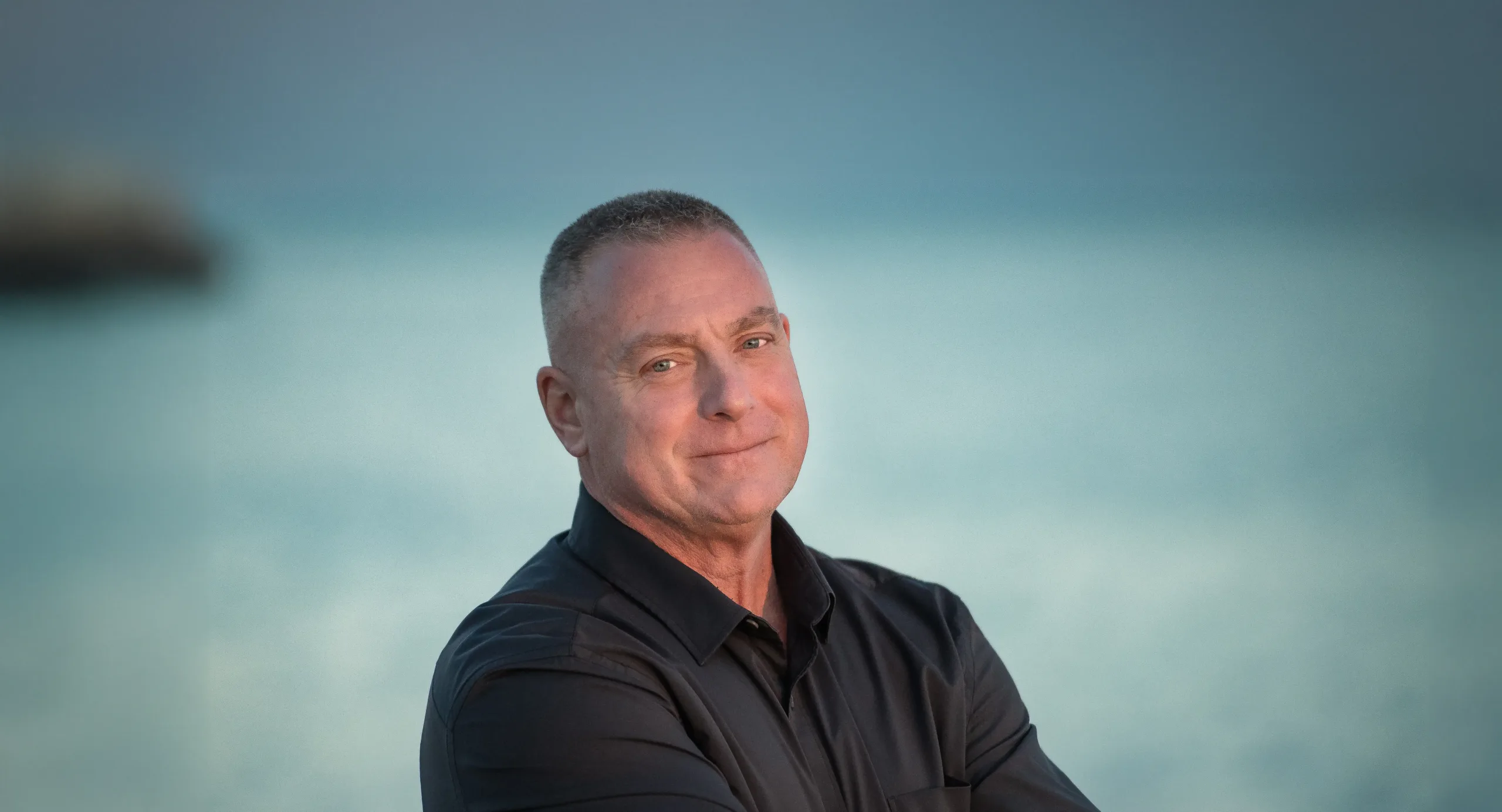 Grande Testimonial John Grande, plaintiff in Grande v. HFT, standing in front of a body of water.