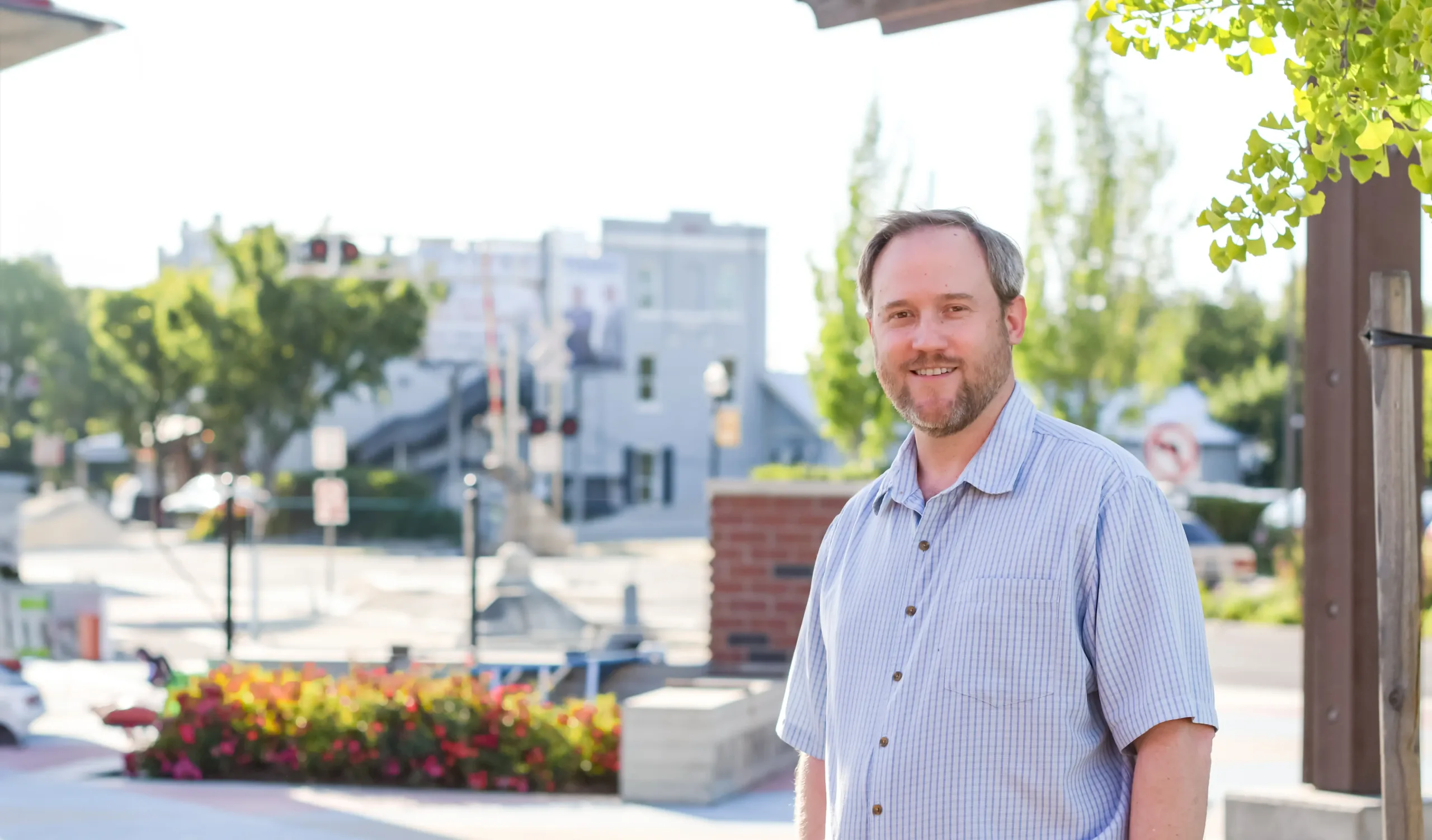 Isaac Newman, plaintiff in Newman v. EGEA, smiling in front of downtown Elk Grove, California.
