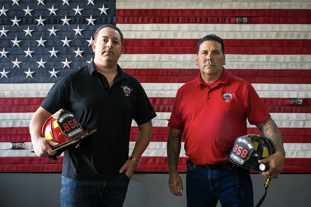 Denver Fire Fighters Local 858 officials in front of an American flag