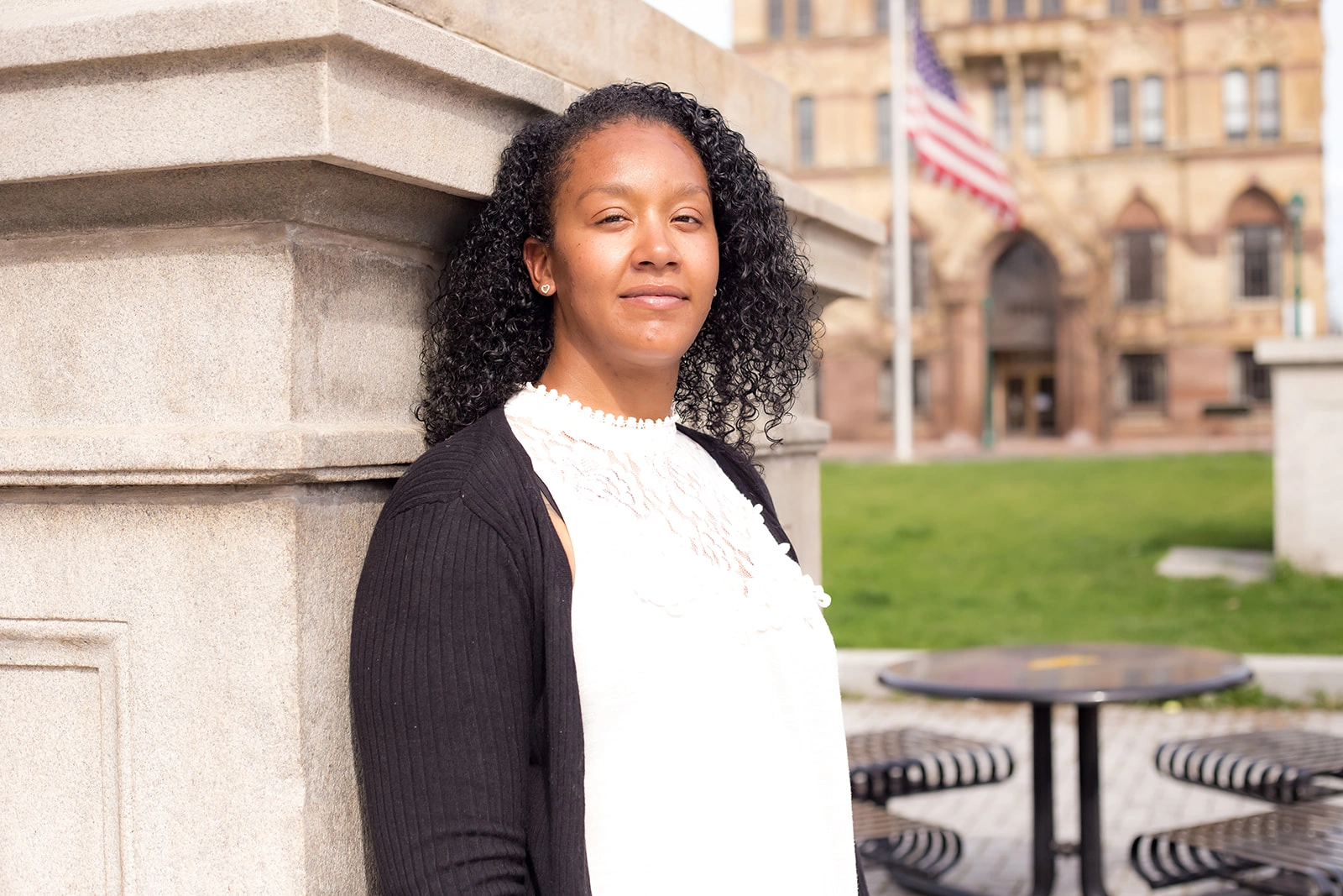 Welch_case thumbnail Amber Welch, plaintiff in Welch v. CSEA, Local 100, leaning against a stone pillar.