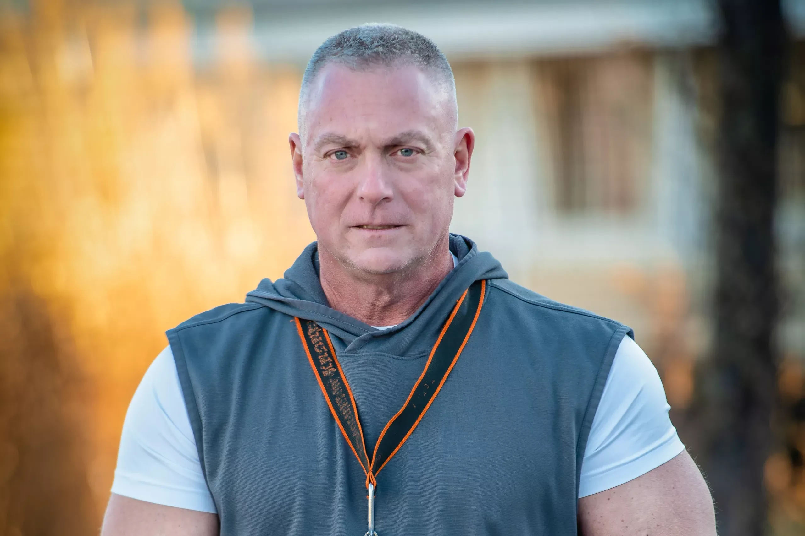 Grande_homepage John Grande, plaintiff in Grande v. HFT, holding a stack of papers on a tennis court with a serious expression on his face.