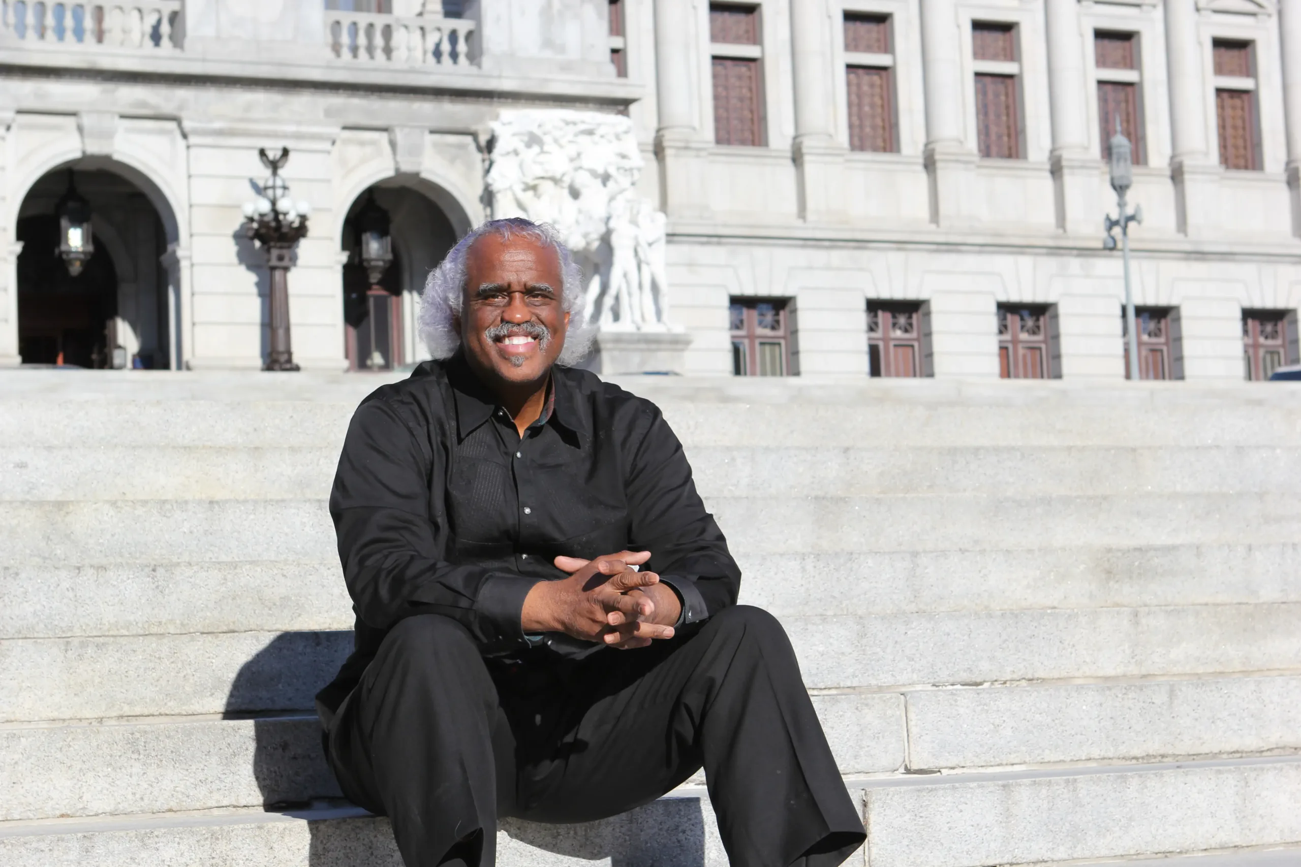 Curtis Thompson, plaintiff in Thompson v. AFSCME, DC 89, sitting on the Capitol Steps in front of the Harrisburg, Pennsylvania capitol building.