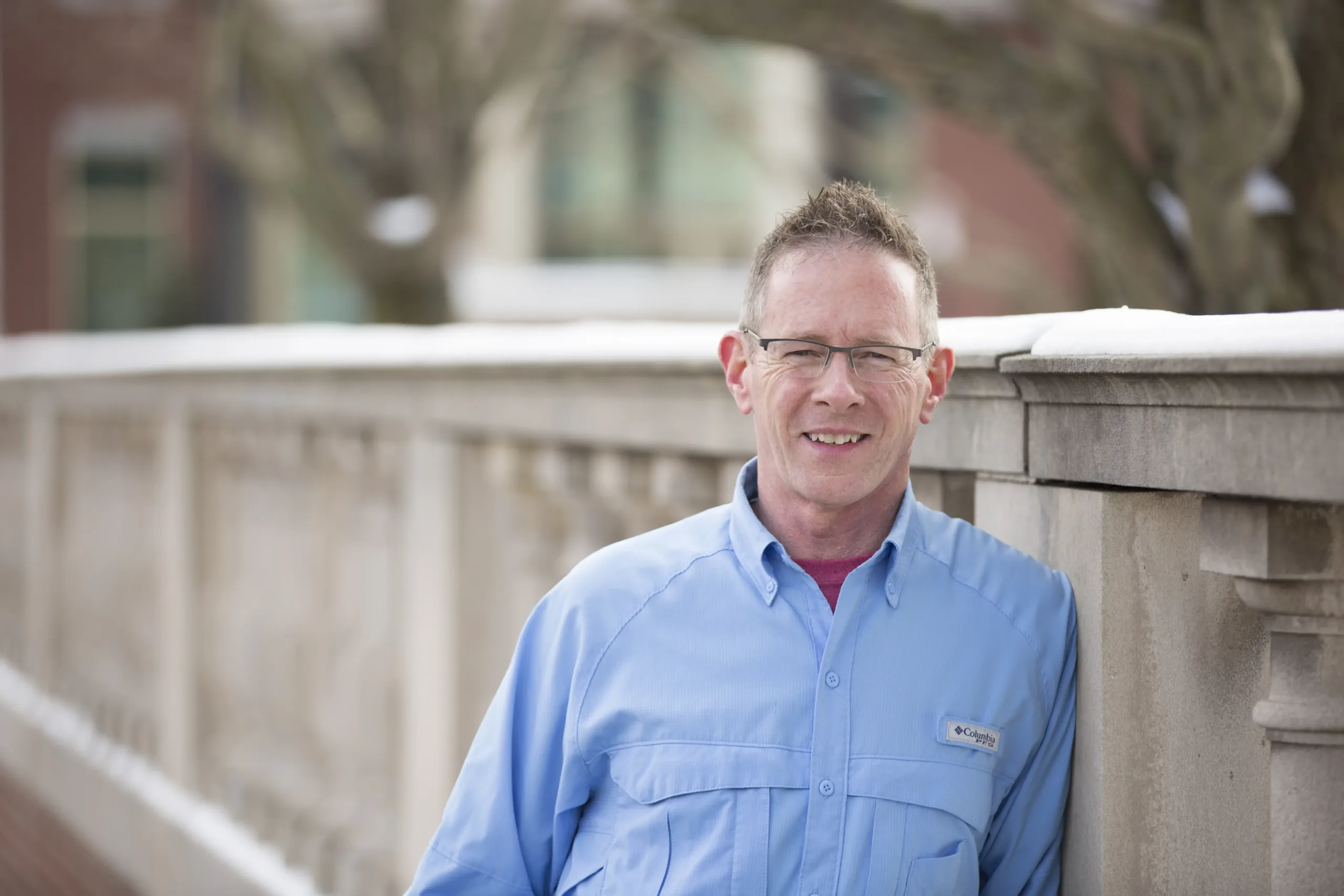 Greg Hartnett, lead plaintiff in Hartnett v. PSEA, leaning against a stone railing.