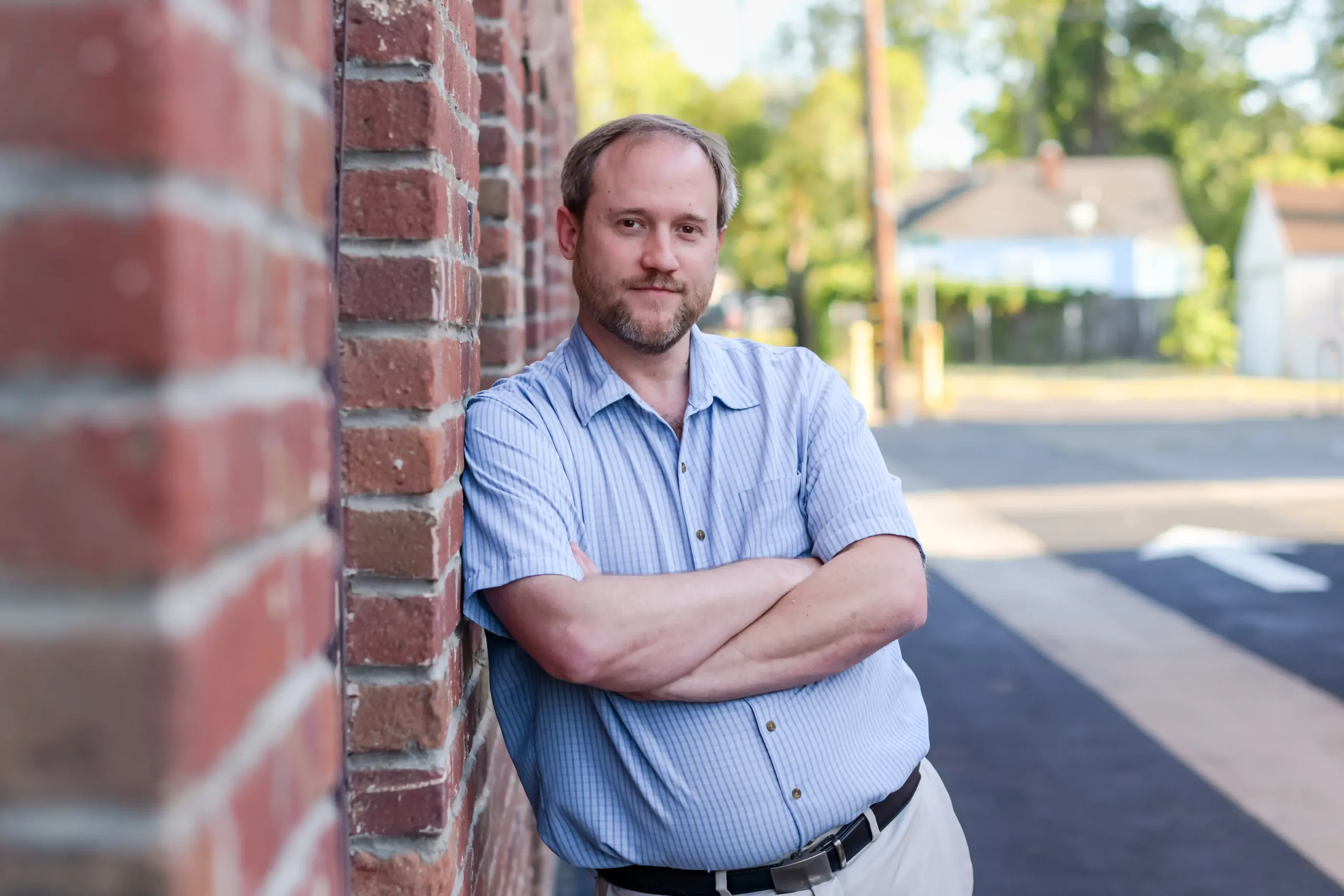 Newman 10 Isaac Newman, plaintiff in Newman v. EGEA, leaning against a brick wall.